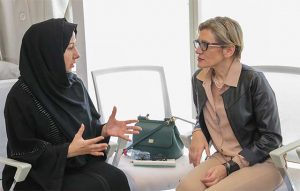 Marilena Di Coste discussing with woman during meeting